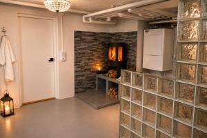 a tasting room with a brick wall and a refrigerator at Boende i Vimmerby in Vimmerby