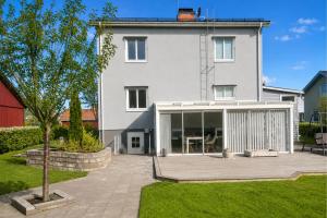 a white house with a patio in front of it at Boende i Vimmerby in Vimmerby