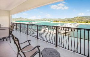 a balcony with a view of the water and boats at Luxury Marina Suite 2BR in Playa Flamingo