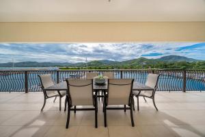 a table and chairs on a balcony with a view of the water at Luxury Marina Suite 2BR in Playa Flamingo
