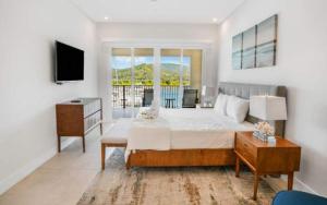 a bedroom with a large bed and a television at Luxury Marina Suite 2BR in Playa Flamingo +39 photos