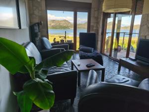 a living room with couches and a plant at Holiday home Haustor with Skadar lake view in Cetinje