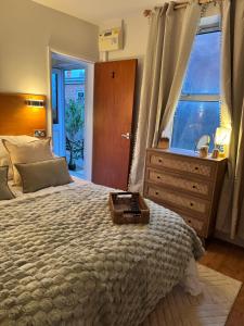 a bedroom with a large bed and a window at The Hidden Gem in Mablethorpe
