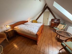 a bedroom with a bed and a table in a attic at Chalupa na Brdech in Obecnice +10 photos
