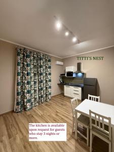 a kitchen with a table and a dining room at Titti's Nest in Casteldaccia +2 photos