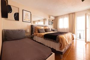 a bedroom with two beds and a window at Guesthouse Rebecca in Makarska