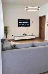 a living room with a couch and a tv at Villa La Vida Dulce Private Pool Near Playa Dorada in Puerto Plata