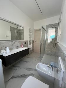 a bathroom with a sink and a tub and a shower at Appartamenti Gemma in Calmasino +45 photos