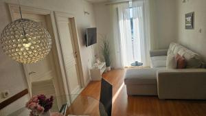 a living room with a couch and a glass table at Apartment Adriatica City in Makarska
