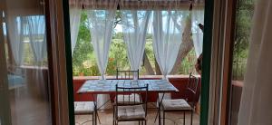 a table and chairs in front of a window at Sole e Sale in Sardegna in Pula