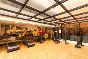 a group of people in a gym with equipment at Hotel da Costa By Nobile in Aracaju