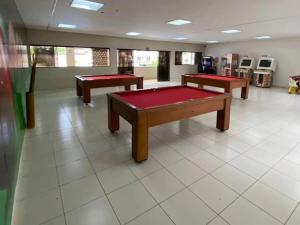 a room with two ping pong tables in it at Suite no Boulevard suite hotel in Caldas Novas
