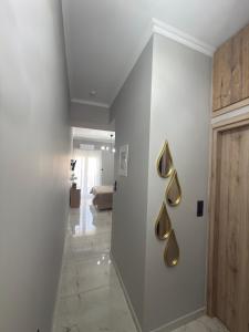 a hallway with a white wall with gold accents at Eleni’s Mountainview Central Studio by the Sea in Loutraki
