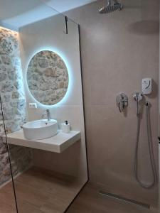 a bathroom with a sink and a shower at 70 sqm sea view apartment in Parga