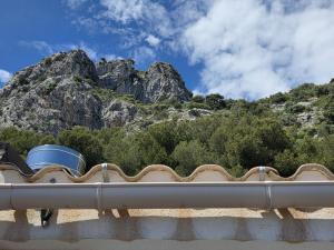 a roof of a building with a mountain in the background at Duplex Residence with Monte Carlo Sea View & 2 Terraces in Roquebrune-Cap-Martin