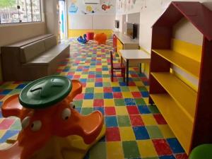 a play room with a toy dog on the floor at Suite no Boulevard suite hotel in Caldas Novas +7 photos