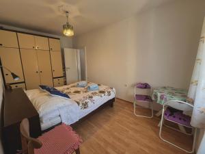 a bedroom with a bed and a table and chairs at APARTMAN RUŽICA in Cres