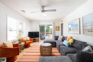 a living room with a couch and a tv at This Home Has It All Location Amenities & More in Duck