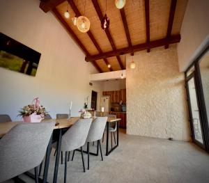 a dining room with a wooden table and chairs at Salt Cabins in Ocniţa +25 photos