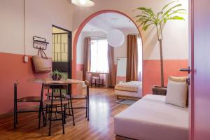 a living room with a table and a room with a couch at Hotel San Fernando in Mexico City