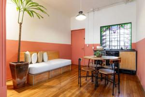 a room with a couch and a table with a palm tree at Hotel San Fernando in Mexico City