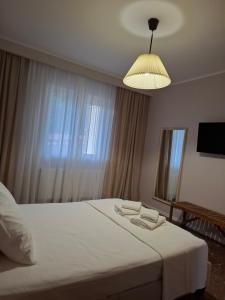 a bedroom with a white bed with a large window at 70 sqm sea view apartment in Parga