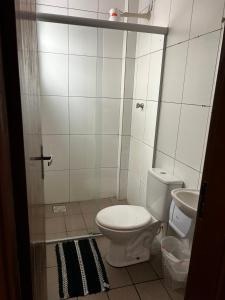 a small bathroom with a toilet and a sink at HL Hotel in Pelotas