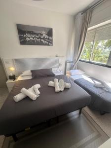 a bedroom with two beds with towels on them at Urban Rifugio - Camera privata con bagno vicino EUR in Rome