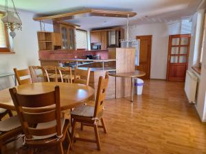 a kitchen and dining room with a table and chairs at Vila Rozmital in Příbram