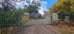 a green gate in front of a house at Applegate lodge in Clarens