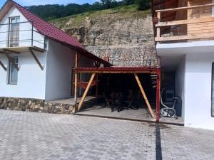 a building with a patio with chairs in it at Casa de vacanță la Dunăre in Sviniţa