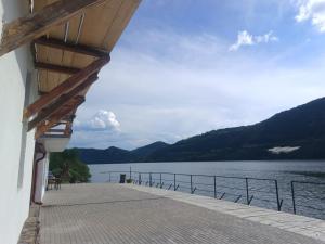 a dock with a view of the water and mountains at Casa de vacanță la Dunăre in Sviniţa