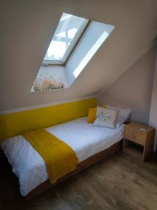 a bedroom with a bed and a window in a attic at Agroturystyka Kuźnia in Neple
