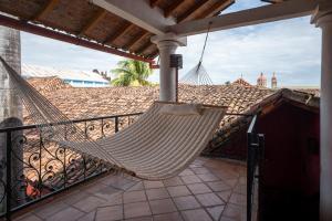 a hammock hanging from a balcony on a house at Hotel Casa del Consulado in Granada +102 photos