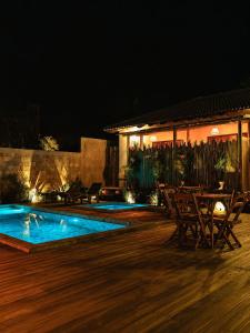 a patio with a swimming pool at night at Vila Inca in Alto Paraíso de Goiás