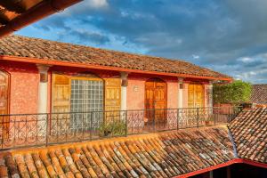 a balcony of a house with a roof at Hotel Casa del Consulado in Granada