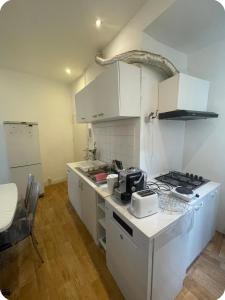 a kitchen with white cabinets and a counter top at Grace Family Home in Brussels +4 photos