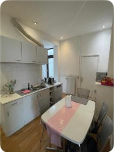a kitchen with a table and chairs in a room at Grace Family Home in Brussels
