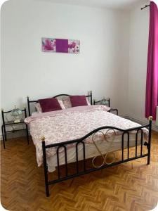 a bedroom with a bed with a black frame at Grace Family Home in Brussels