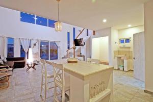 a kitchen and living room with a counter and chairs at SUNRISE Heated Pool Ocean View Walk to beach in La Ventana