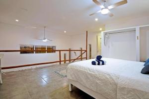 a bedroom with a bed and a ceiling fan at SUNRISE Heated Pool Ocean View Walk to beach in La Ventana +51 photos