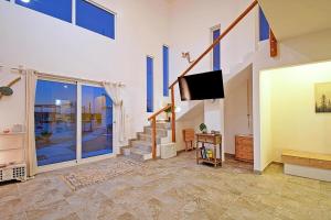 a living room with a flat screen tv on a wall at SUNRISE Heated Pool Ocean View Walk to beach in La Ventana
