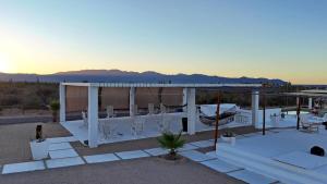 a patio with white furniture and a view of the ocean at SUNRISE Heated Pool Ocean View Walk to beach in La Ventana