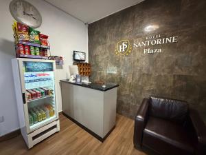 a store with a refrigerator and a chair and a clock at Hotel Santorine Plaza - Itabira - Próximo a Fundação Cultural Carlos Drummond Andrade in Itabira +62 photos