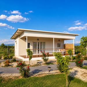 a small white house with a garden at Agroktima Arta - Farm Stay in Arta