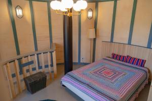 a bedroom with a bed and a lamp in a room at Biskopsdal in Karuna