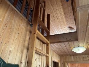an inside view of a wooden barn with a ceiling at Summerhouse Torfalundur in Blönduós