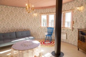 a living room with a couch and a table at Biskopsdal in Karuna