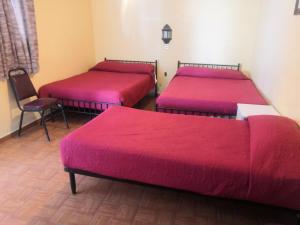 a room with three beds and a couch at Arisa in Oaxaca City