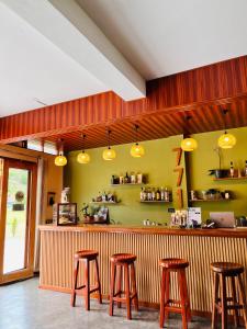 a bar with four stools in a restaurant at Hostal Gocta in Cocachimba